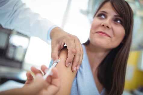 Adult Diabetes. A doctor delivers a shot to a woman with diabetes.